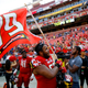 Maryland offensive lineman Ellis McKennie waves a flag in remembrance of offensive lineman Jordan McNair, who died after collapsing on a practice field during a spring practice, after an NCAA college football game against Texas, Saturday, Sept. 1, 2018, in Landover, Md.